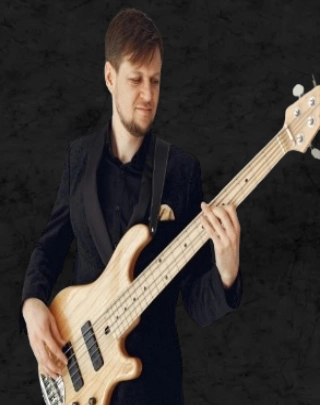 Person playing in a rock‑style setting promtoing Bass lessons.