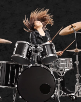 Person playing in a rock‑style setting promtoing Drum lessons.
